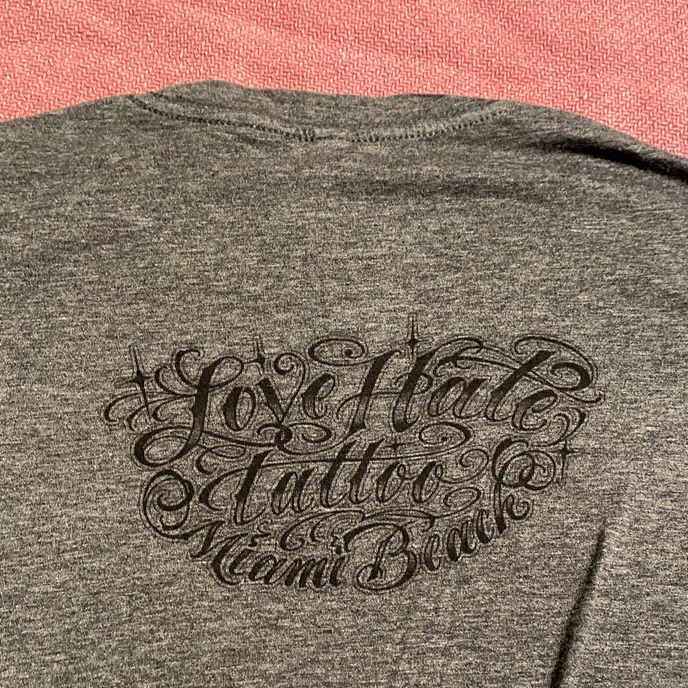 Love Hate Tattoo Miami Beach/Ami James Apparel woman’s tshirt.
Large. Super Soft